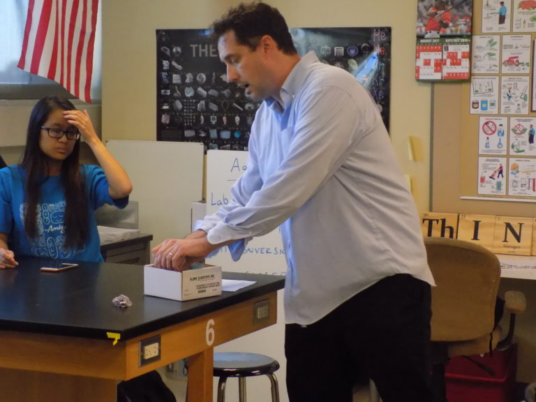 Martin Berryman, Chemistry Club Advisor, Explaining an Experiment. Photo Taken by Falyn Kelley