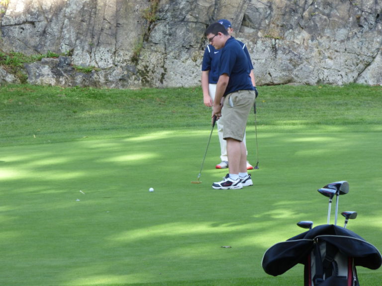 Sophomore Sean Lightbody getting ready to putt