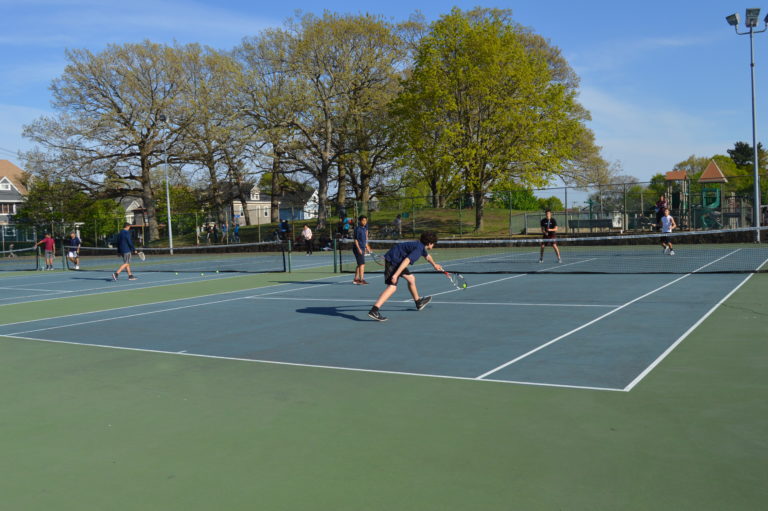 Sophomore Liam Schwab hitting the ball to his opponent. Photo by David Cartledge.