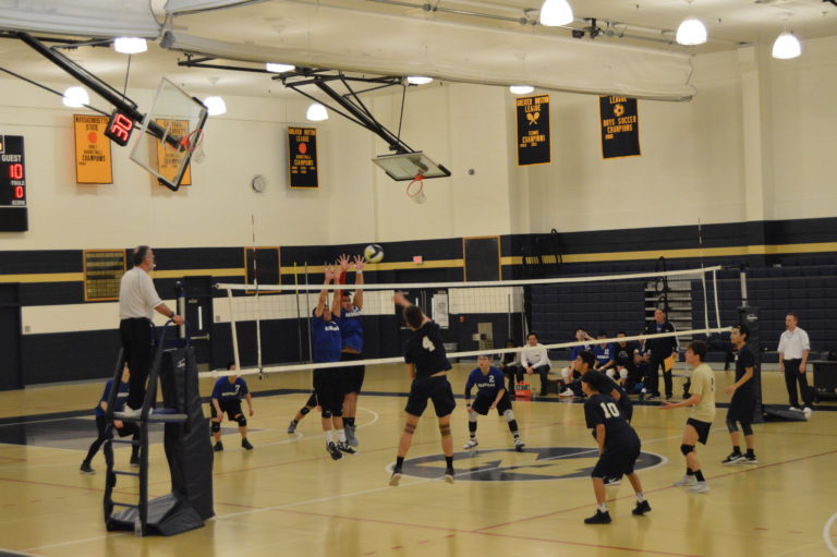 Player spiking the ball over the net