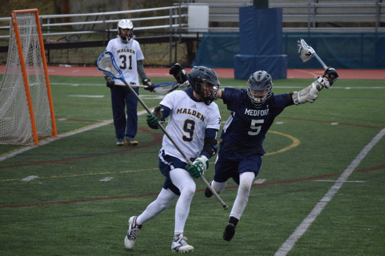 Sophomore Zaki Greige running past a player