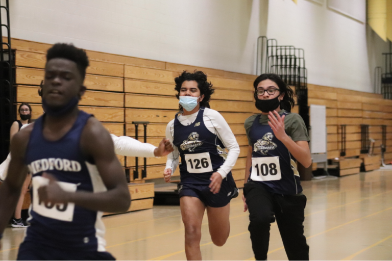 Sophomore Rolando Mejia (left) and freshman Joshua Arevalo (right) running the 55 yard dash. Photo by Carlos Aragon.