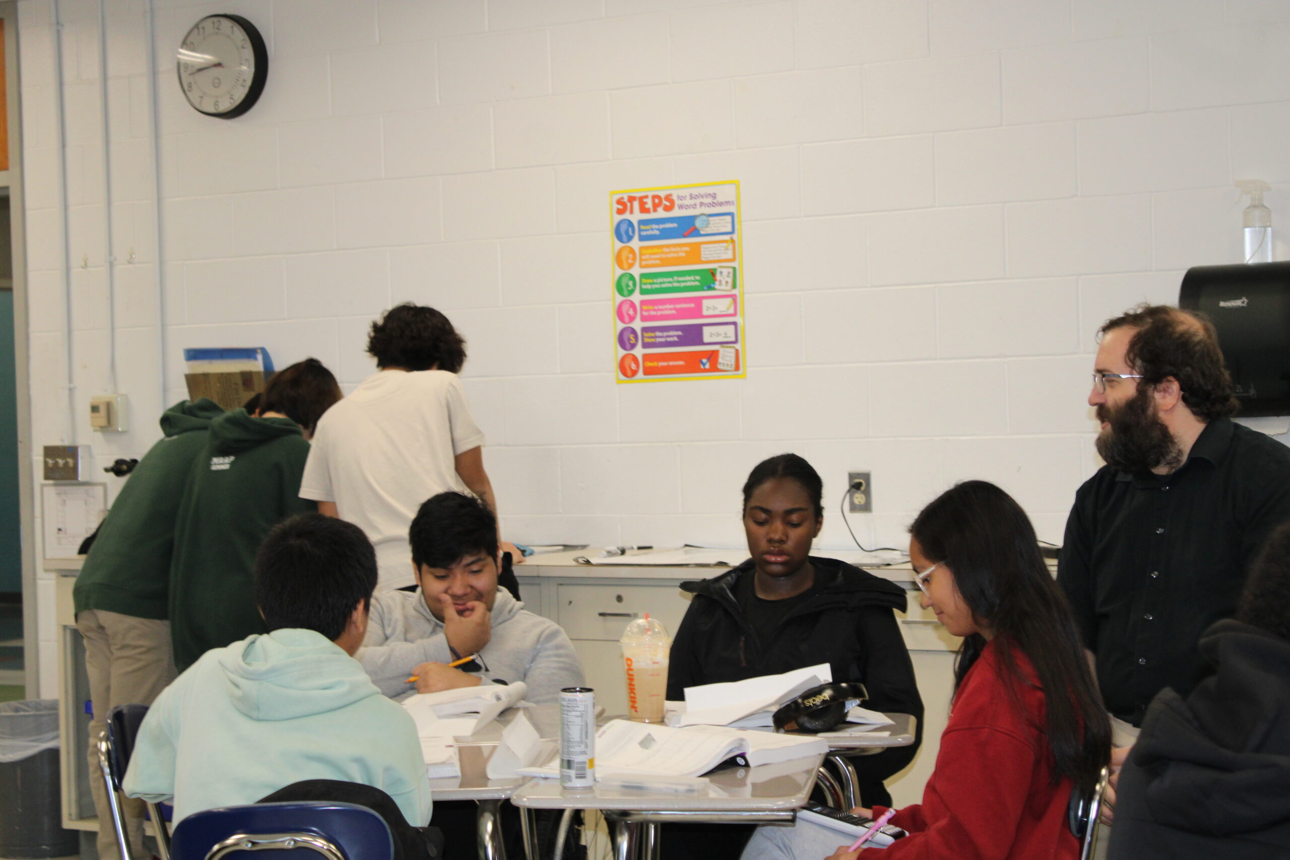 Mr. Malivuk looks upon his students as they work in their math books. REVA UPADHAYAY